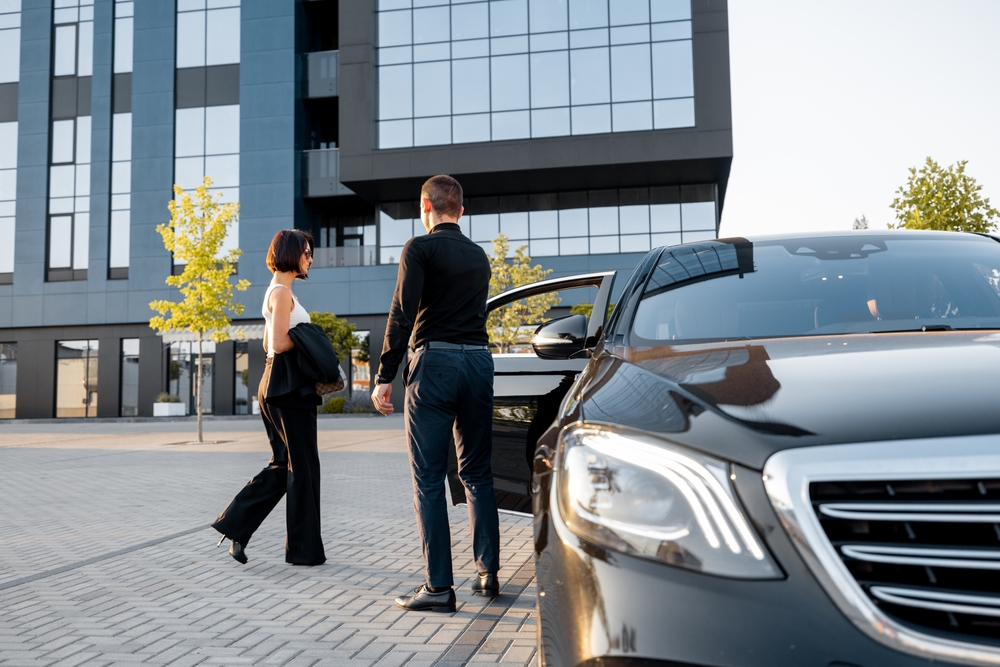 Chauffeur,Helps,An,Elegant,Business,Woman,Gets,In,Car,,Opening